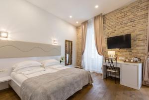 Posteľ alebo postele v izbe v ubytovaní Pellegrini Luxury Rooms