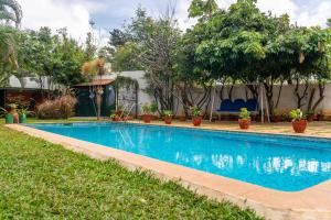 a swimming pool in the yard of a house at StayVista at Firefly Homestay with Pvt Pool & Terrace Access in Bangalore