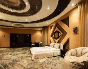 a hotel room with a bed and a circular ceiling at Forum Hotel in Tyumen