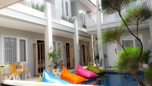 a building with colorful pillows next to a swimming pool at Mantra Gili in Gili Trawangan