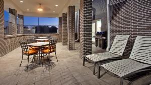 a patio with a table and chairs and a kitchen at Candlewood Suites Kearney by IHG in Kearney