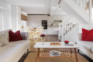 a living room with a couch and a table at Carr Cottage in Leeds