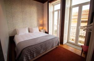 Uma cama ou camas num quarto em Casa com Historia