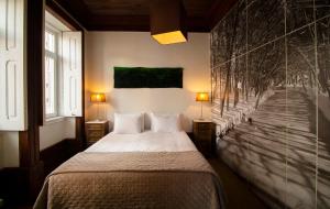 Uma cama ou camas num quarto em Casa com Historia