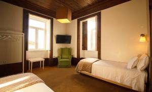 Uma cama ou camas num quarto em Casa com Historia