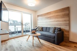 a living room with a couch and a table at Apartments Gustav by Schladming-Appartements in Schladming