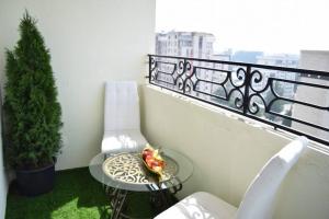 a plate of food on a table on a balcony at Bishkek Sunny Apartment in the center in Bishkek