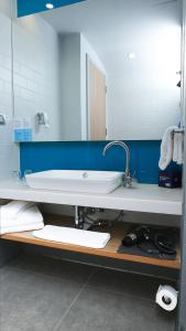 a bathroom with a sink and a large mirror at Holiday Inn Express - Istanbul - Atakoy Metro, an IHG Hotel in Istanbul