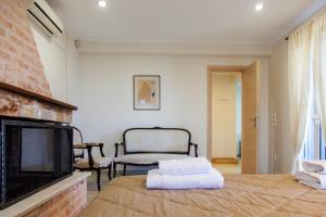 a living room with a bed and a fireplace at Villa Anna in Athani
