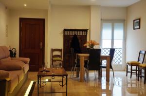 a living room with a couch and a table at Dúplex Centro Parking Ronda in Ronda