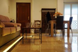 a living room with a couch and a table at Dúplex Centro Parking Ronda in Ronda