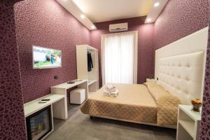 a bedroom with a bed and a tv in it at Royal House Napoli Centro, by ClaPa Group in Naples