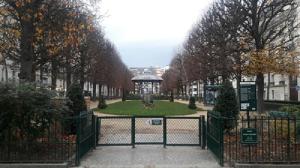 a gate to a park with a gazebo and trees at Villa Eiffel Mademoiselle in Paris