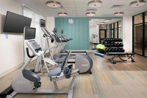 a gym with treadmills and exercise equipment in a room at Holiday Inn Express Pensacola Downtown, an IHG Hotel in Pensacola