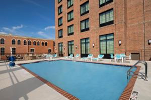 a large building with a pool in the middle of it at Holiday Inn Express Pensacola Downtown, an IHG Hotel in Pensacola