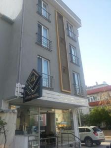 a building with a car parked in front of it at GÜVEN HOTEL in Çanakkale