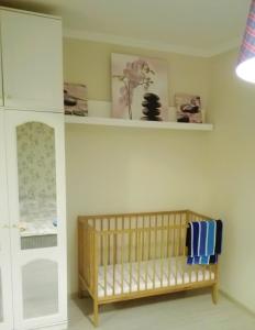 a baby room with a crib and shelves at Двухкомнатная квартира Smart-Home in Daugavpils