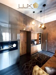 a living room with a couch and a kitchen at Lux A28 in Novi Sad