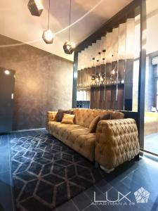 a living room with a couch in the middle at Lux A28 in Novi Sad