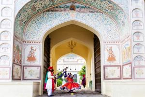 two people in colorful costumes standing in an arch way at Castle Kalwar in Pachār