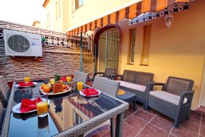 a patio with a table and chairs with fruit on it at Cozy Townhouse With Ocean Views in Costa Adeje in Adeje