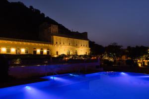 a large building with blue lights in front of it at Castle Kalwar in Pachār