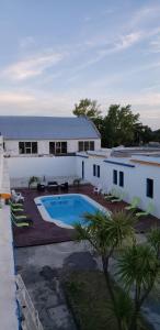 un edificio con piscina frente a él en Piriápolis Hostel & suites, en Piriápolis