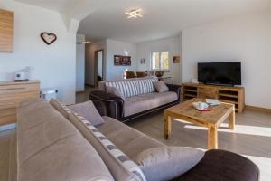 a living room with a couch and a table at WHITE HOUSE PENTHOUSE in Dramalj