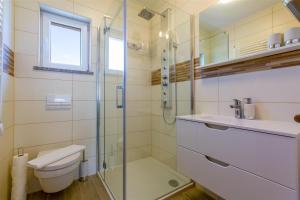 a bathroom with a shower and a toilet and a sink at WHITE HOUSE PENTHOUSE in Dramalj +28 photos