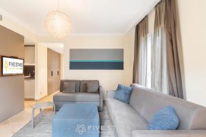 a living room with a couch and a table at Villa Artemys - Five Stars Holiday House in Saint-Jean-Cap-Ferrat