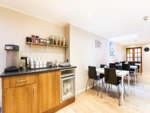 a kitchen and dining room with a table and chairs at Lost Guest House Aberdeen in Aberdeen
