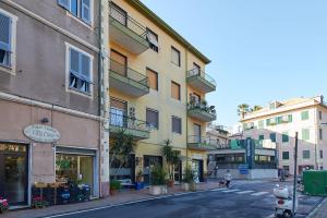 a person walking a dog in front of a building at Borgomare in Finale Ligure