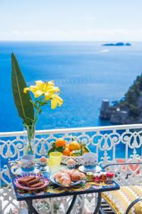 a table topped with plates of food and drinks at Casa Nilde in Positano