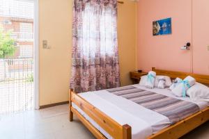 A bed or beds in a room at Roussa's Apartments