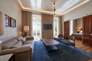 a living room with a couch and a table at Les Suites at The Cliff Bay - PortoBay in Funchal