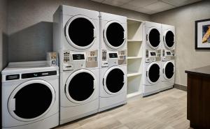 four washers and dryers in a laundry room at Holiday Inn Express Niagara-On-The-Lake, an IHG Hotel in Niagara on the Lake