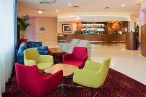 a living room filled with furniture and a large window at Holiday Inn Derby Riverlights, an IHG Hotel in Derby