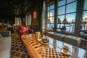 a lobby with a table with cups and chairs at Riffelalp Resort 2222m in Zermatt