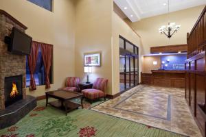 a living room with a fireplace and a tv at Holiday Inn Express Hotel & Suites Cleveland-Streetsboro by IHG in Streetsboro