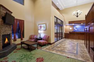a living room with a fireplace and a tv at Holiday Inn Express Hotel & Suites Cleveland-Streetsboro, an IHG Hotel in Streetsboro