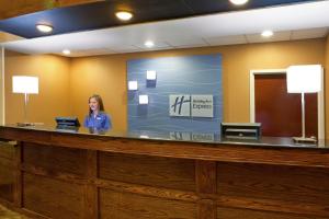 a woman standing in front of a counter in a kitchen at Holiday Inn Express Hotel & Suites Cleveland-Streetsboro, an IHG Hotel in Streetsboro