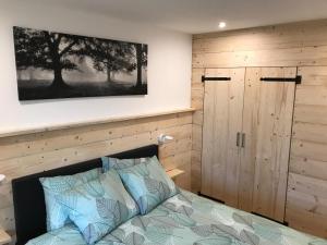 a bedroom with a bed and a wooden wall at Appartement Familie Willems Winterberg 3 in Winterberg