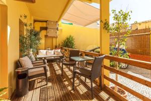 
a patio area with a table, chairs, and a balcony at Best Western Hotel Dom Bernardo in Faro

