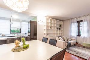 a kitchen and living room with a table and a couch at Welcome to Milan and More! in Varedo