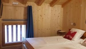 a small room with a bed and a window at La Courtine 3 in Verchaix