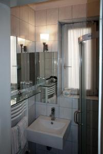 a bathroom with a sink and a mirror at Apartments ABA Zagreb in Zagreb