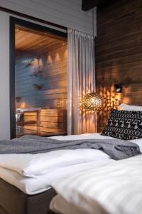 a bedroom with two beds and a chandelier at Lapland Hotels Sky Ounasvaara in Rovaniemi