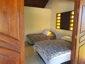 A bed or beds in a room at Casa da Rua 1 - Cavalcante/GO