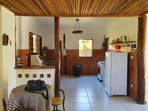 a kitchen with a refrigerator and a table and chairs at Casa da Rua 1 - Cavalcante/GO in Cavalcante