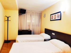 A bed or beds in a room at Hotel Santa Catalina by Bossh Hotels